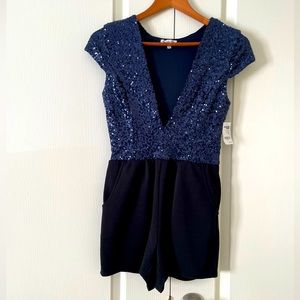 Plunging V neck romper shorts with a sequins top. Blue and black